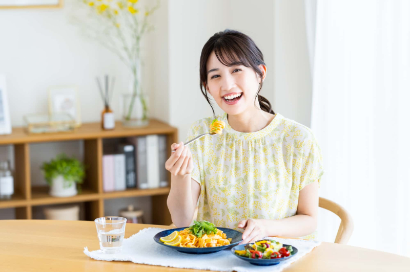根管治療を終えて快適に食事をする女性