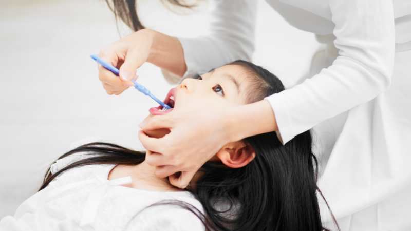 仕上げ磨きをする親子